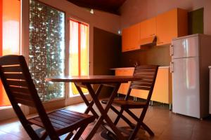 a kitchen with a table and chairs and a refrigerator at Relax in Vieste