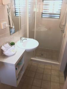 a bathroom with a sink and a shower at City Motor Inn in Toowoomba