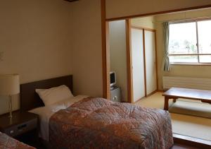 Postel nebo postele na pokoji v ubytování Hotel Meribel Tsugaike