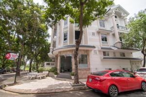 a red car parked in front of a house at Bin Bin Hotel 1 - Near RMIT University in Ho Chi Minh City