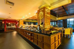 a restaurant with a counter with food on it at VOUK Hotel and Suites Nusa Dua Bali in Nusa Dua