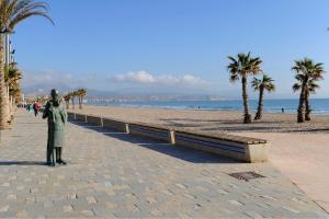 a statue of a person standing on a beach at Hotel Castilla Alicante in Alicante