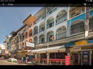 a large building with tables and chairs in front of it at Tuk’s Sports Bar in Pattaya Central +5 photos