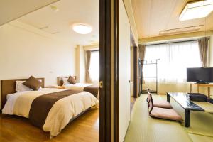 Llit o llits en una habitació de Hotel Sunmi Club Bekkan