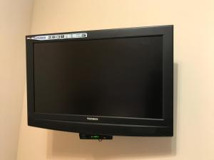 a flat screen tv hanging on a wall at Motel Sujet in Bohodukhiv