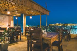 a restaurant with a wooden table and chairs at night at Tripli Hotels Prithvi Palace in Jaisalmer