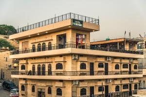 a building with a balcony on top of it at Tripli Hotels Prithvi Palace in Jaisalmer