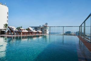 a large swimming pool on top of a building at Sofiana My Khe Hotel & Spa- Rooftop Pool Bar in Danang