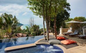 a swimming pool with a view of the ocean at Rawi Warin Resort And Spa - SHA Extra Plus in Ko Lanta