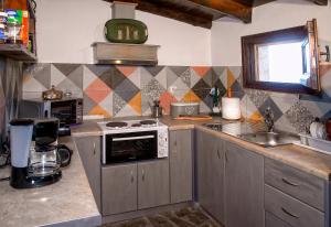 a kitchen with a stove and a sink at Eleni Country Cottage 2 in Feneos