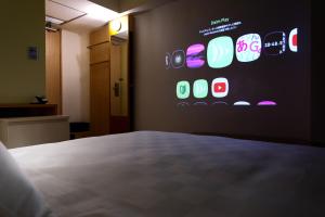 a room with a wall with a bunch of apps on it at Shibuya Tokyu REI Hotel in Tokyo