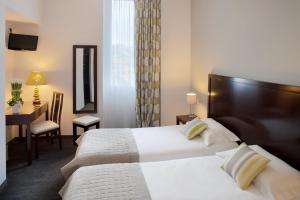 Voodi või voodid majutusasutuse Hôtel Relais Acropolis toas