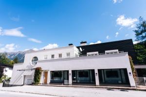 a white building with a black roof at Residenz Kaiser Franz Josef in Bad Gastein