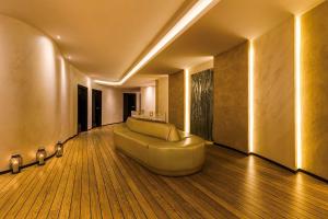 a large living room with a couch in the middle at Grand Lubicz Uzdrowisko Ustka in Ustka