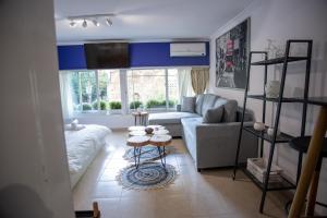 a living room with a couch and a table at Thessaloniki Center Small Studio Apartment in Thessaloniki