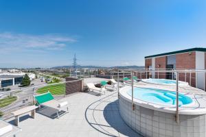 a hot tub on the roof of a building at Record Hotel in Settimo Torinese