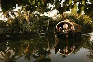a group of people on a boat in the water at Spice Coast Cruises - Houseboat in Alleppey