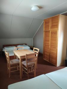 um quarto com uma mesa e cadeiras e duas camas em Apartmany Bobule em Destné v Orlických horách