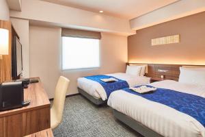 Una cama o camas en una habitación de &and COMFY HOTEL Kumamoto Jo View