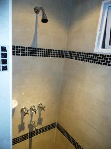 a bathroom with a shower with black and white tiles at Ayres Sur in Mar del Plata