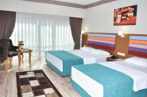 A bed or beds in a room at Hanem Hotel