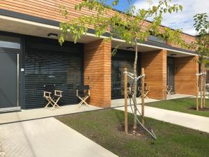 a building with black garage doors and two chairs at Nussböckgut in Linz