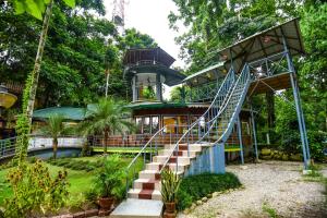 a house with a staircase leading up to it at Aranya Jungle Resorts in Lataguri