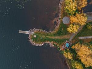 an aerial view of a lake with a dock at Revontuli Resort Rooms in Hankasalmi