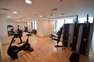 a gym with treadmills and exercise bikes in a room at KeyHost - Spacious Studio at Sparkle Tower Dubai Marina - K1280 in Dubai