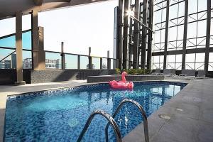 a swimming pool with a pink float in a building at KeyHost - Spacious Studio at Sparkle Tower Dubai Marina - K1280 in Dubai