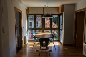 ein Esszimmer mit Tisch und Stühlen und einem Fenster in der Unterkunft Bidasoa by Basquelidays in Irún