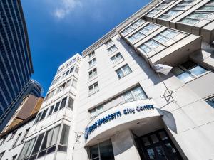 a tall white building with a sign on it at Hotel Best Western City Centre in Brussels