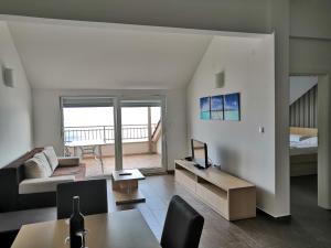 a living room with a couch and a bed at Apartments Nostro in Omiš