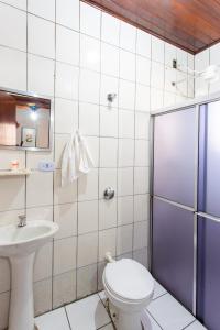 a bathroom with a toilet and a sink at Hotel America in Jacareí +51 photos