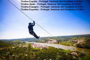 a man hanging on a zip line over a river at Casa del Ingeniero 4 Hab 8 Pers 3 Chimeneas con horno in Puerto de la Laja