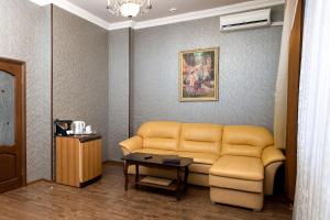 sala de estar con sofá y mesa en Hotel Astoria, en Volgograd