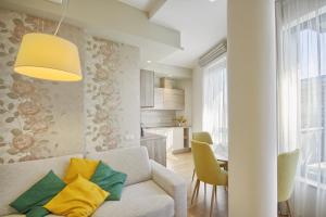 een woonkamer met een bank en een tafel bij Valensia Apartment in Druskininkai