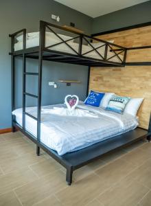 a bedroom with a bunk bed with white and blue pillows at Ray Hostel in Chiang Mai