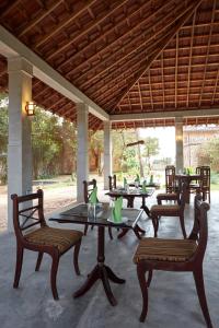 a group of tables and chairs on a patio at Villa Sunbird in Negombo