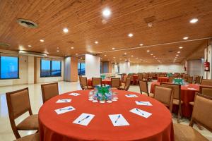 a conference room with a red table and chairs at Hotel Golf Mar in Maceira +46 photos