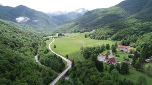 an aerial view of a valley with a house and a road at Hotel Mladost in Tjentište