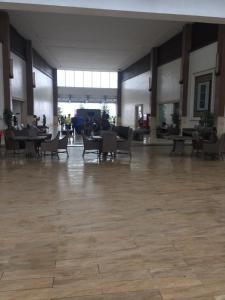 a large room with chairs and tables in a building at TAGAYTAY WIND CONDO, 4pax,3BEDS,FF,AC WIFI in Tagaytay