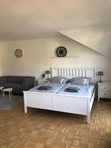 a bedroom with a white bed and a couch at Altstadt Quartier Hameln in Hameln