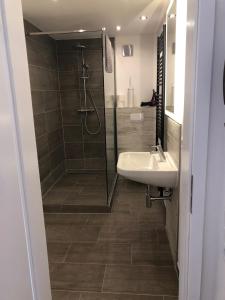 a bathroom with a shower and a sink at Altstadt Quartier Hameln in Hameln +25 photos