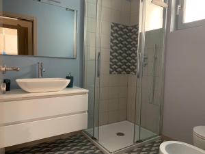 a bathroom with a glass shower and a sink at Agordo Suite in Agordo +15 photos