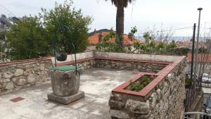 a stone retaining wall with a bench in a garden at Apartment Dubrava in Dubrovnik