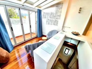 a living room with a table and some windows at Almocabar Luxury Apartment in Ronda