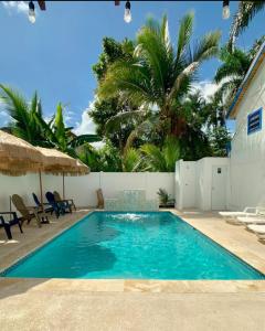 a swimming pool with blue water in a yard at Blue House Joyuda in Cabo Rojo