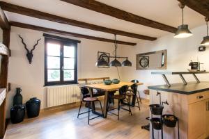a kitchen and dining room with a table and chairs at La Maison du Batelier - Quartier historique Petite Venise in Colmar