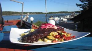 a plate of food on top of a table at Vuosnaisten Meriasema in Kustavi +27 photos